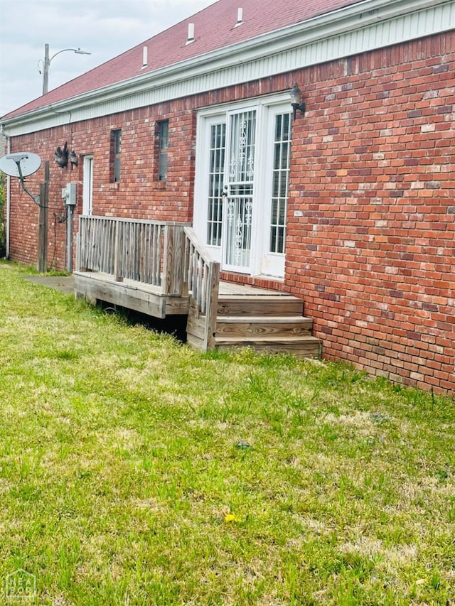 2208 John Cir, Newport, AR 72112 - rear view of house featuring a yard and brick siding