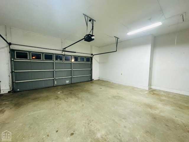 2208 John Cir, Newport, AR 72112 - garage with baseboards and a garage door opener