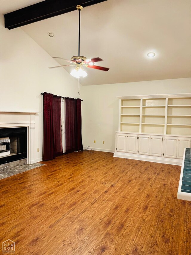 2208 John Cir, Newport, AR 72112 - unfurnished living room with light wood-type flooring, ceiling fan, baseboards, and vaulted ceiling with beams