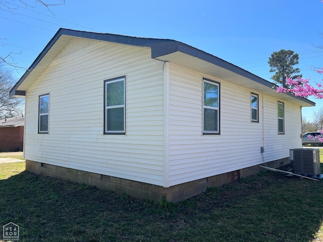 view of property exterior with a yard, cooling unit, and crawl space
