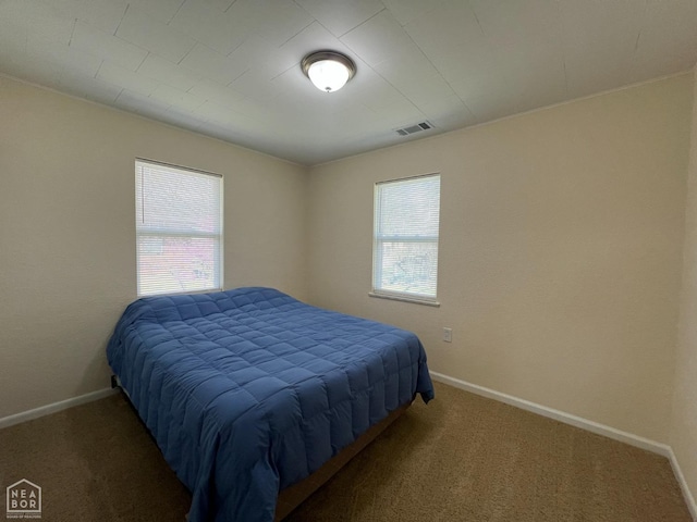bedroom featuring carpet, visible vents, and baseboards