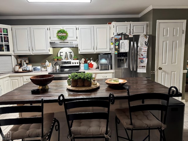 515 6th, Marked Tree, AR 72365 - kitchen featuring appliances with stainless steel finishes, under cabinet range hood, white cabinets, and ornamental molding