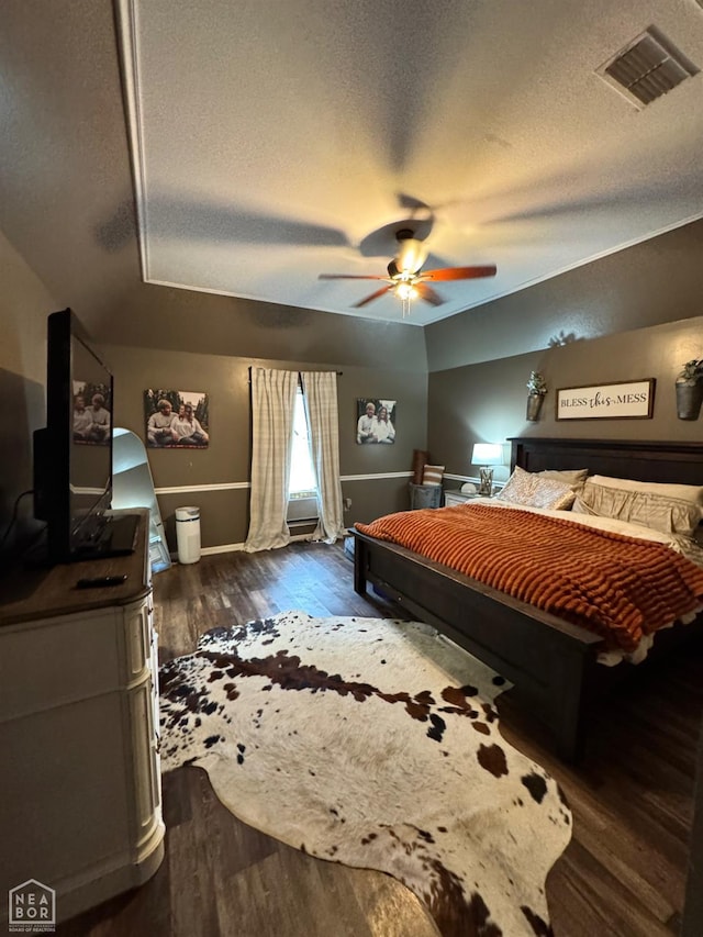 515 6th, Marked Tree, AR 72365 - bedroom with a textured ceiling, dark wood-style floors, and ceiling fan