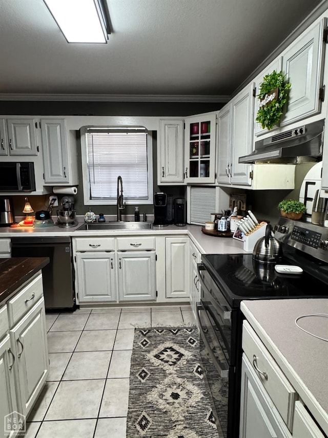 515 6th, Marked Tree, AR 72365 - kitchen with black range with electric stovetop, dishwashing machine, under cabinet range hood, crown molding, and light tile patterned flooring
