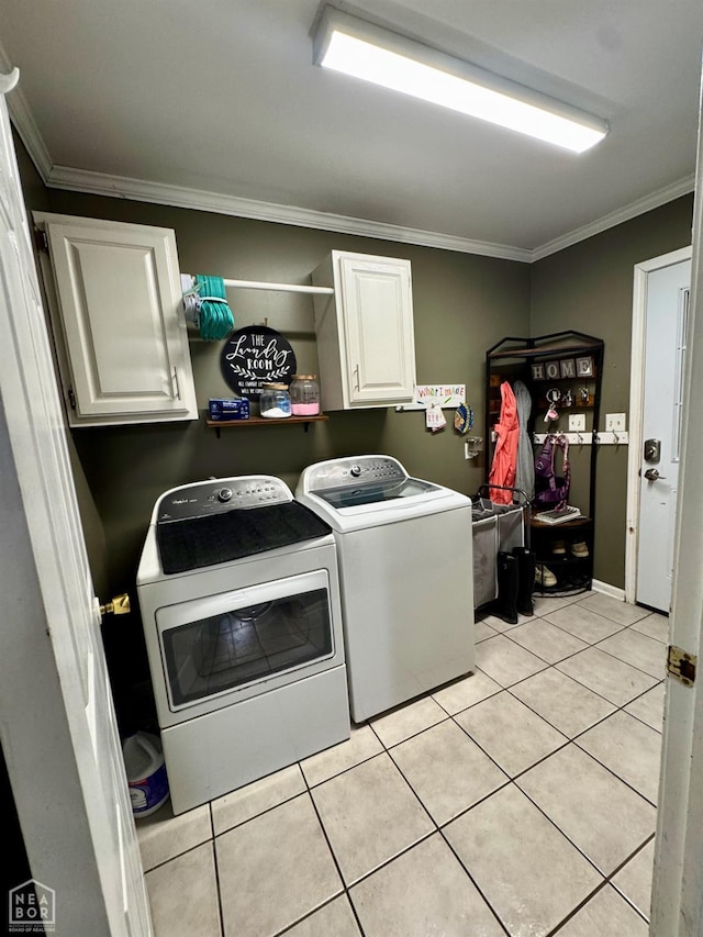 515 6th, Marked Tree, AR 72365 - laundry room featuring independent washer and dryer, cabinet space, ornamental molding, and light tile patterned flooring