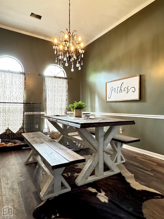 515 6th, Marked Tree, AR 72365 - dining room featuring a chandelier, wood finished floors, and ornamental molding