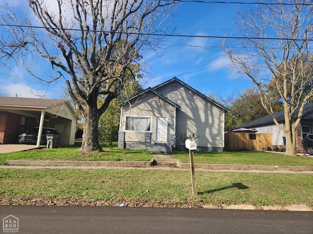 bungalow-style house featuring an attached carport and a front lawn