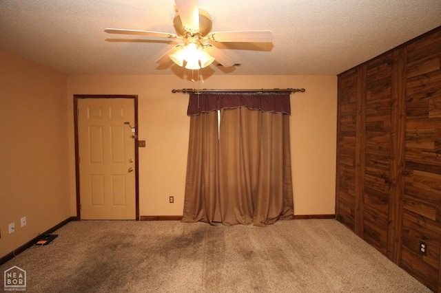 1704 Rector Rd, Paragould, AR 72450 - foyer featuring carpet floors, ceiling fan, a textured ceiling, and baseboards