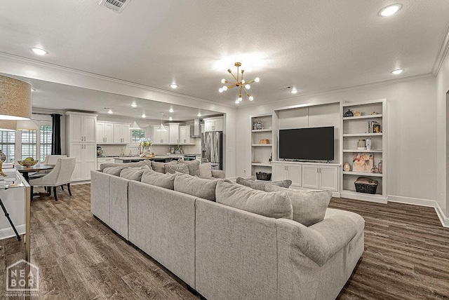 4328 Lynx Ln, Jonesboro, AR 72405 - living room featuring crown molding, a chandelier, dark wood-style floors, recessed lighting, and a textured ceiling