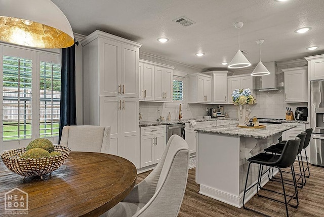 4328 Lynx Ln, Jonesboro, AR 72405 - kitchen featuring wall chimney exhaust hood, dishwasher, a kitchen island, white cabinetry, and recessed lighting