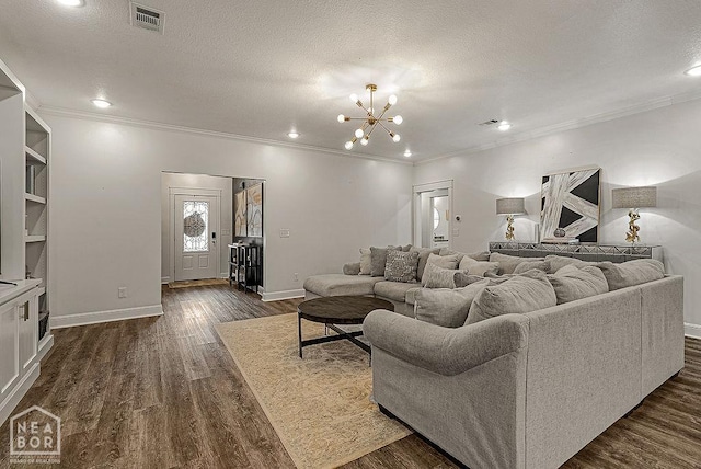 4328 Lynx Ln, Jonesboro, AR 72405 - living area with crown molding, dark wood-style flooring, a chandelier, a textured ceiling, and recessed lighting