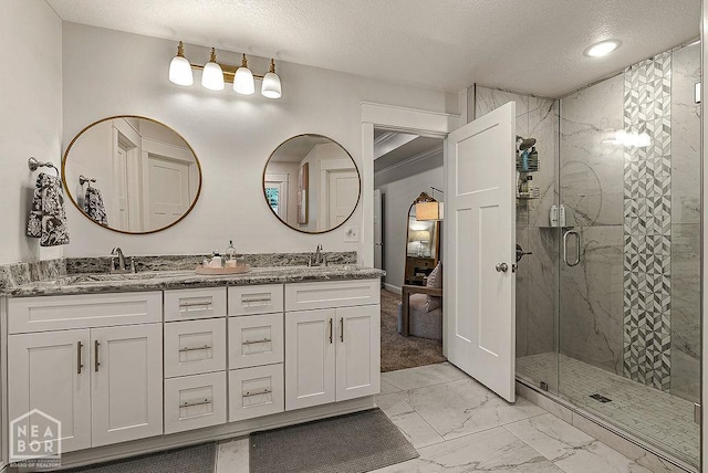 4328 Lynx Ln, Jonesboro, AR 72405 - full bathroom featuring marble finish flooring, a textured ceiling, a stall shower, and double vanity