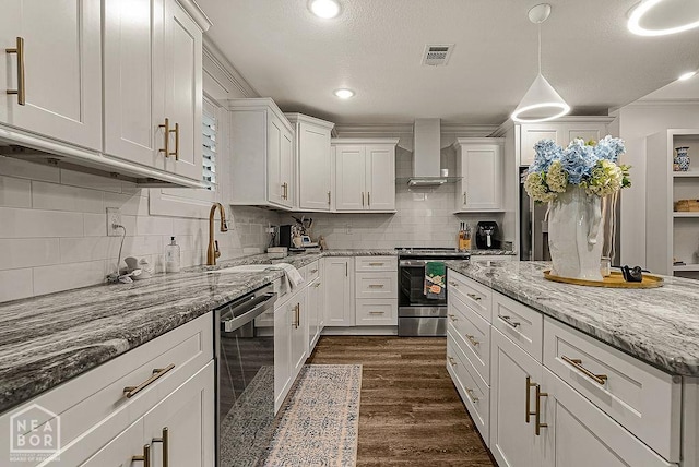 4328 Lynx Ln, Jonesboro, AR 72405 - kitchen featuring wall chimney range hood, stainless steel appliances, white cabinetry, tasteful backsplash, and recessed lighting