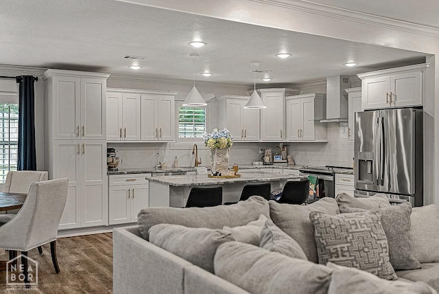 4328 Lynx Ln, Jonesboro, AR 72405 - kitchen with stainless steel appliances, wall chimney exhaust hood, crown molding, open floor plan, and dark wood-type flooring