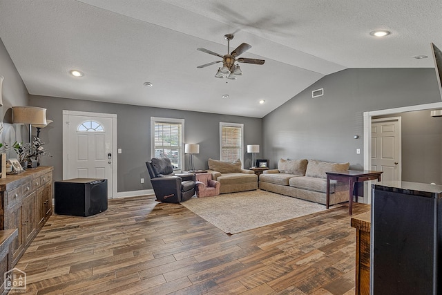 5010 S 28th St, Paragould, AR 72450 - living room featuring ceiling fan, lofted ceiling, wood finished floors, and a textured ceiling