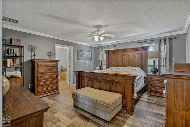 5010 S 28th St, Paragould, AR 72450 - bedroom with hardwood / wood-style floors, ornamental molding, a textured ceiling, and ceiling fan