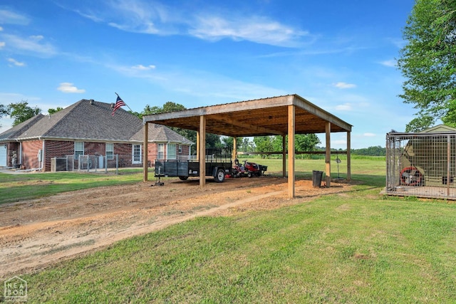 430 County Road 751, Jonesboro, AR 72405 - view of grassy yard featuring a detached carport, driveway, and an outbuilding