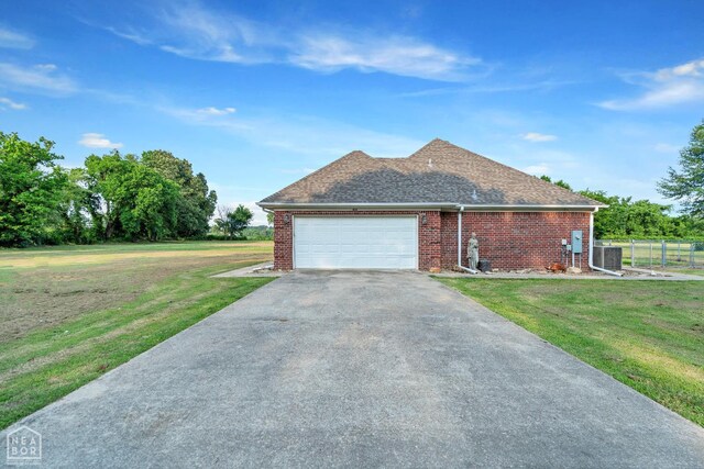 430 County Road 751, Jonesboro, AR 72405 - view of side of home with asphalt driveway, central AC, brick siding, and a garage