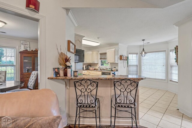 430 County Road 751, Jonesboro, AR 72405 - kitchen featuring a kitchen breakfast bar, a peninsula, crown molding, light tile patterned flooring, and stone counters