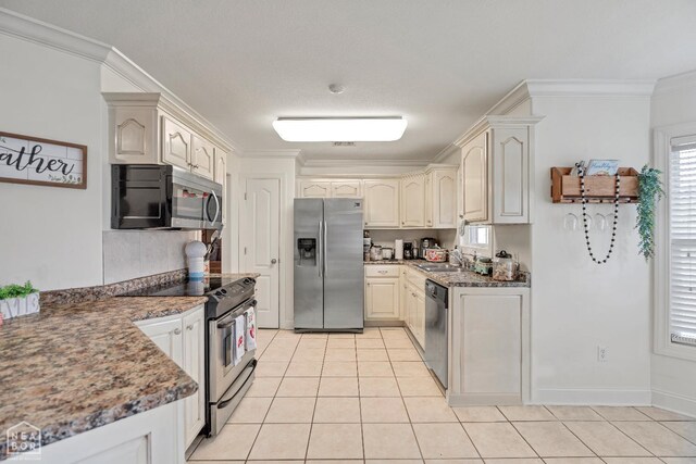 430 County Road 751, Jonesboro, AR 72405 - kitchen with appliances with stainless steel finishes, crown molding, a sink, light tile patterned floors, and dark stone counters