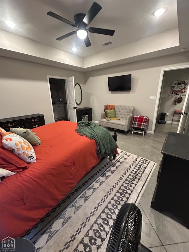 bedroom featuring a raised ceiling, baseboards, and ceiling fan