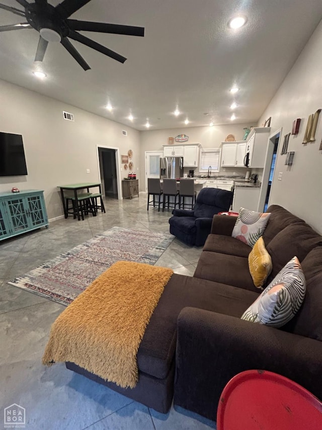 living room featuring a ceiling fan and recessed lighting