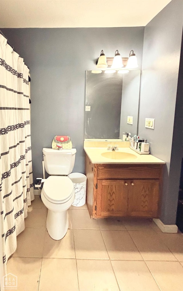 bathroom with toilet, tile patterned floors, curtained shower, and vanity