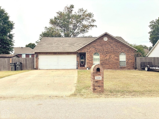single story home with an attached garage, fence, driveway, and brick siding