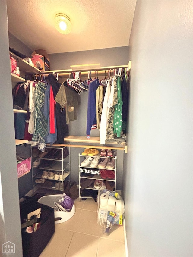 spacious closet with tile patterned floors