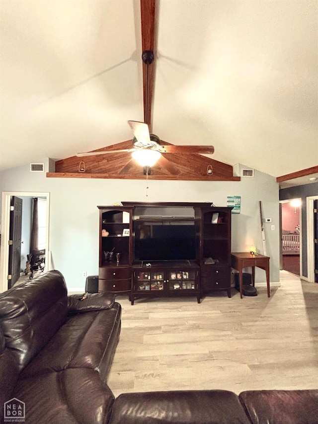 living area with ceiling fan, visible vents, vaulted ceiling with beams, and wood finished floors