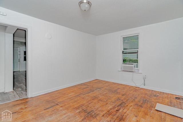 403 N Bridge St, Jonesboro, AR 72401 - unfurnished room with wood-type flooring, cooling unit, and baseboards