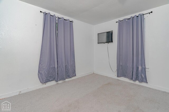 403 N Bridge St, Jonesboro, AR 72401 - carpeted empty room featuring baseboards