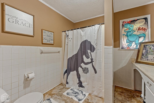 406 E Ash St E, Keiser, AR 72351 - bathroom with tile walls, crown molding, a textured ceiling, a wainscoted wall, and toilet