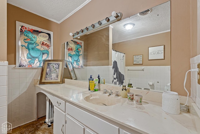 406 E Ash St E, Keiser, AR 72351 - full bath with a textured ceiling, crown molding, tile walls, vanity, and a wainscoted wall