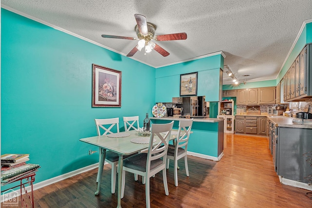 406 E Ash St E, Keiser, AR 72351 - dining area with ornamental molding, a textured ceiling, a ceiling fan, and light wood-style flooring