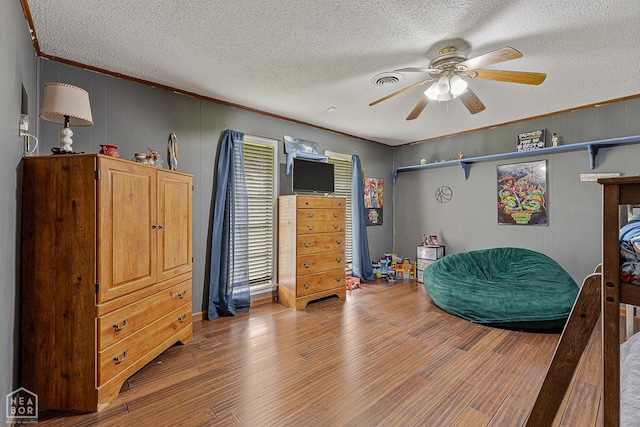 406 E Ash St E, Keiser, AR 72351 - sitting room featuring ceiling fan, a textured ceiling, wood finished floors, and crown molding