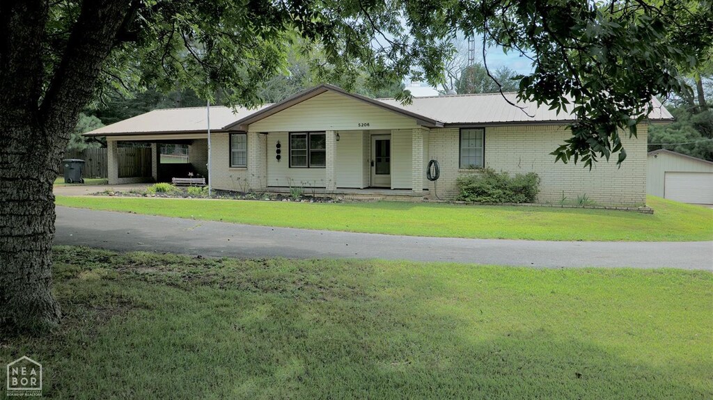 5206 Johnwood Dr, Jonesboro, AR 72404 - ranch-style home featuring a front yard, an outdoor structure, brick siding, and metal roof
