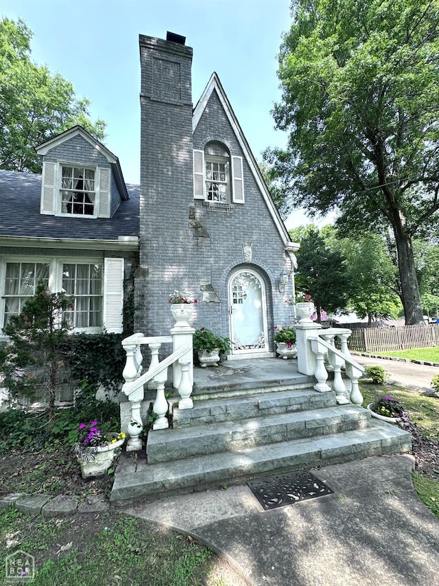 582 N 4th Ave, Piggott, AR 72454 - view of front of home featuring a chimney and brick siding