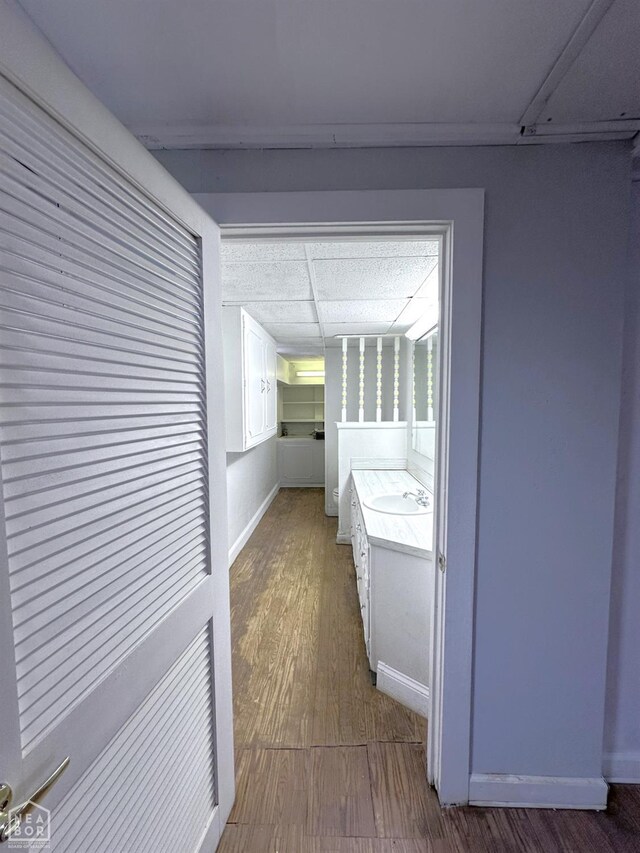 582 N 4th Ave, Piggott, AR 72454 - bathroom with wood finished floors, vanity, and baseboards