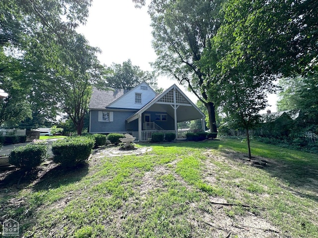 582 N 4th Ave, Piggott, AR 72454 - rear view of house with a lawn