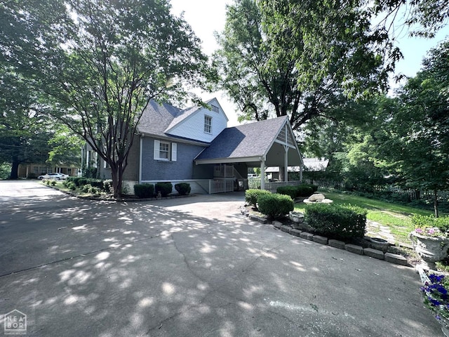 582 N 4th Ave, Piggott, AR 72454 - view of front of property featuring concrete driveway, a porch, brick siding, and roof with shingles