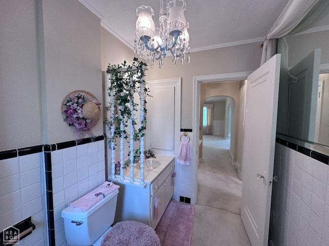 582 N 4th Ave, Piggott, AR 72454 - bathroom featuring vanity, crown molding, a chandelier, tile walls, and toilet
