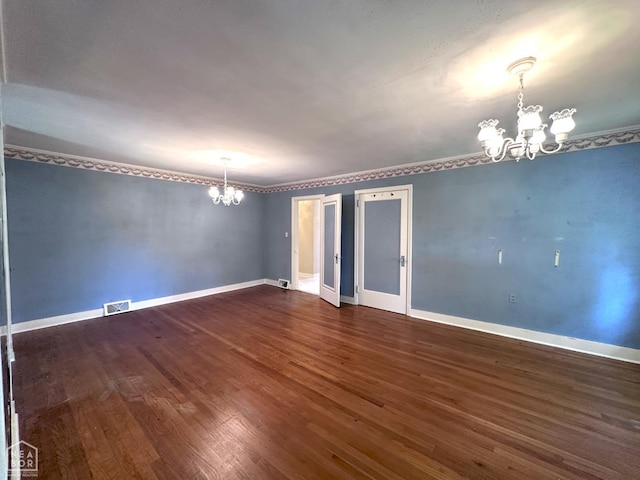 582 N 4th Ave, Piggott, AR 72454 - empty room with a chandelier, dark wood finished floors, and baseboards