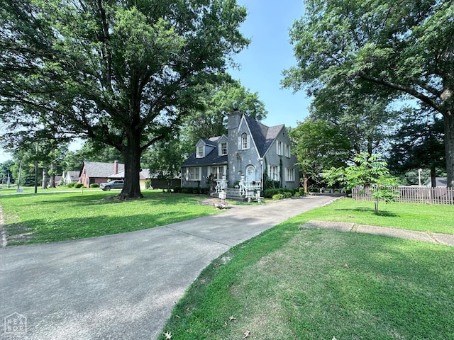 582 N 4th Ave, Piggott, AR 72454 - view of front of house featuring concrete driveway and a chimney