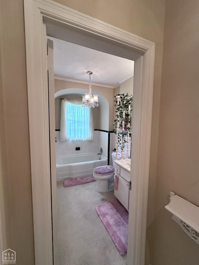 582 N 4th Ave, Piggott, AR 72454 - bathroom with ornamental molding, a garden tub, vanity, a chandelier, and toilet