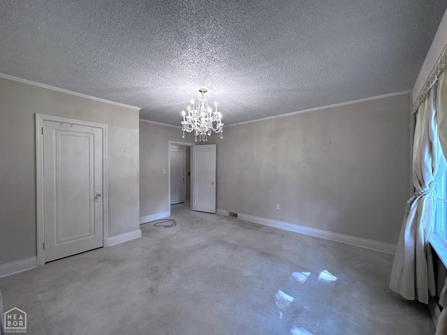 582 N 4th Ave, Piggott, AR 72454 - spare room featuring a chandelier, concrete floors, baseboards, a textured ceiling, and ornamental molding