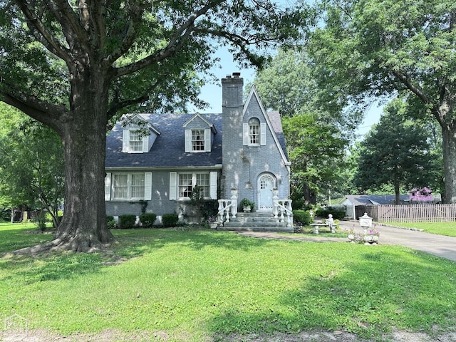 582 N 4th Ave, Piggott, AR 72454 - view of front of home featuring a chimney and brick siding