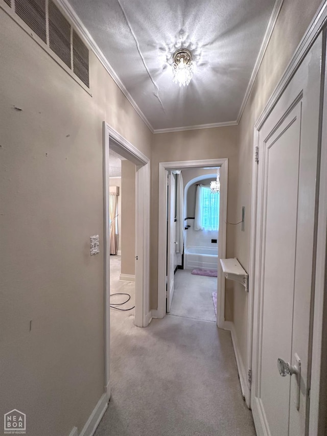 582 N 4th Ave, Piggott, AR 72454 - hall with crown molding, a chandelier, baseboards, and light carpet