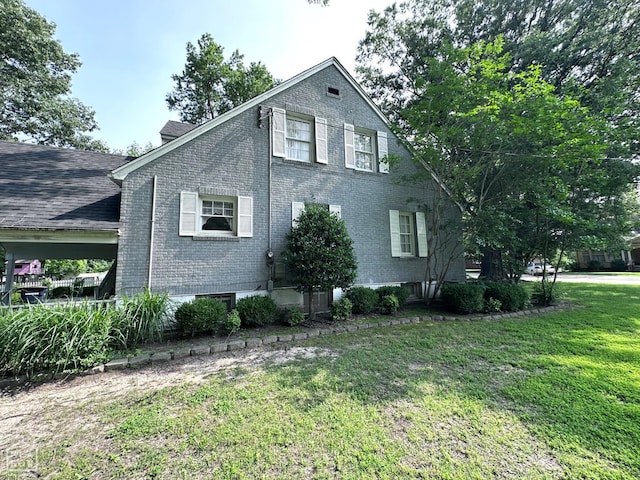 582 N 4th Ave, Piggott, AR 72454 - view of property exterior with brick siding and a yard