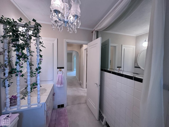 582 N 4th Ave, Piggott, AR 72454 - bathroom with vanity, crown molding, and a chandelier